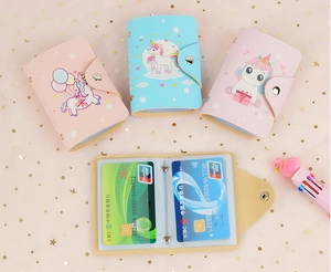 Close-up of unicorn PU leather card holder with snap button and multiple clear slots