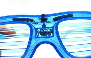 Close-up of blue LED shutter glasses showing battery compartment with button cells