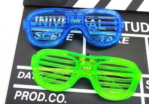 Macro detail of blue and green LED shutter glasses with battery pack on movie slate