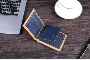 Short faux leather wallet with card slots shown in a professional office setting