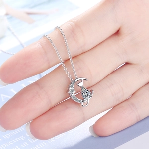 Silver cat pendant necklace with crescent moon and star featuring a teardrop zircon stone