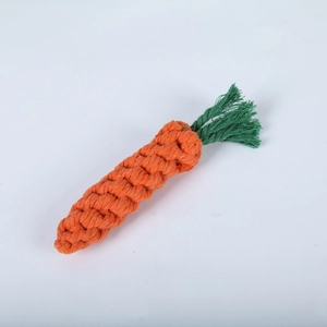 Close-up of durable orange and green woven cotton rope toy in a carrot shape for dogs