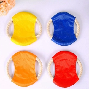 Close-up of four durable cotton rope dog frisbees in yellow, blue, orange, and red
