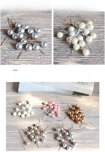 Close-up of 12mm metallic artificial berries in multiple colors with flexible wire stems
