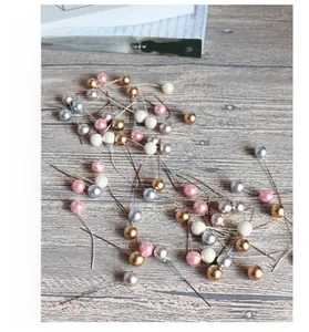 Close-up of multicolored 12mm artificial metallic berries on wire stems for DIY crafts
