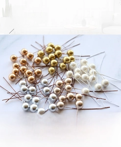 Detail of 10mm metallic artificial berries in gold and silver for Christmas DIY crafts