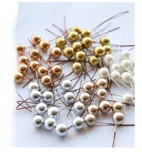 Macro shot of 10mm metallic berries in gold and silver for DIY Christmas crafts