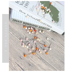 Macro detail of mixed color 8mm artificial berries with thin wire stems for DIY crafts
