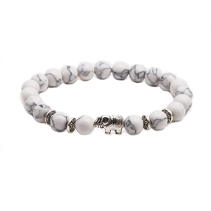 Detail of white turquoise beaded bracelet with silver elephant accent on white background