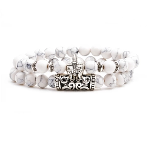 Detail of white turquoise beads and antique silver Viking helmet charm on a beaded bracelet
