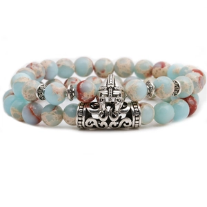 Macro view of beaded bracelet featuring a silver Spartan helmet and stone beads
