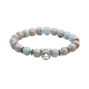 Detailed macro view of natural stone bead bracelet with a silver-toned leopard head charm