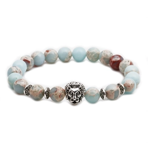 Detail of beaded bracelet with natural stone texture and silver lion head charm