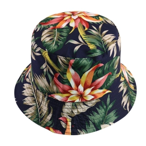 Detail of tropical floral print on a navy blue canvas bucket hat with palm leaf patterns