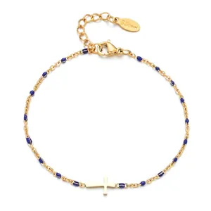 Detailed view of a gold stainless steel bracelet with blue beads and a cross pendant