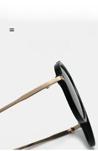 Detail of premium black acetate frame sunglasses with flexible gold metal hinges