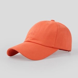 Detail shot of bright orange cotton baseball cap showing curved brim and stitching