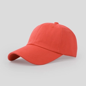 Detail view of a red cotton twill baseball cap showing curved brim and six-panel crown