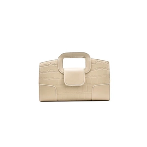 Off-white crocodile pattern handbag with top handle and magnetic flap closure on white base
