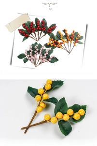 Close-up of artificial red yellow and purple berry stems with realistic green leaves