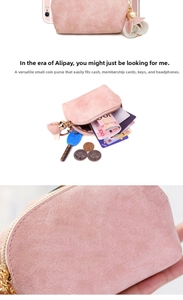 Detail of pink matte coin purse showing zipper, petal charm, and spacious inner storage