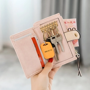 Detail showing pink PU leather key holder with 6 metal hooks and card slot for storage