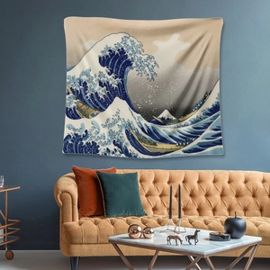 Detailed view of The Great Wave off Kanagawa tapestry hanging above a brown leather sofa