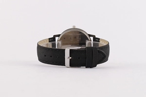 Detail of black textured leather watch strap with polished silver buckle on white background
