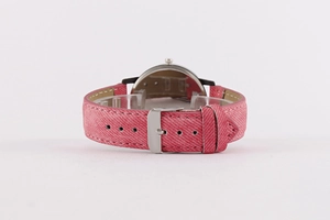 Detailed close-up of pink denim watch strap with silver buckle and leather lining