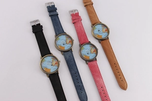 Detail view of four vintage aviator watches with world map dials and denim straps