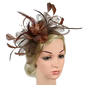 Detail of vintage brown fascinator hat featuring delicate mesh, feathers, and beads