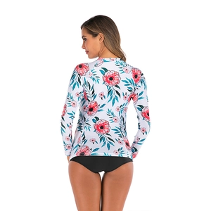 Detail of floral long sleeve bikini top featuring red flowers and green leaves pattern
