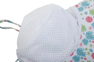 Close-up of baby sun hat featuring breathable white mesh lining and floral print brim