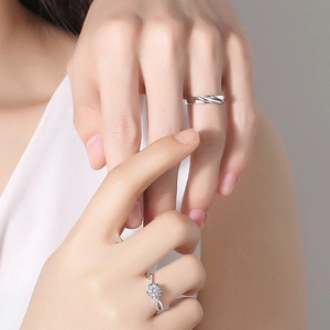 Elegant sterling silver couple rings featuring twisted band and floral pavé diamond design