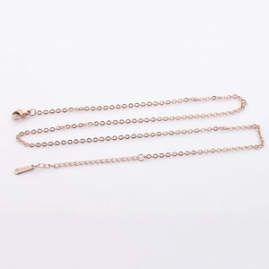 Detail of rose gold stainless steel chain with secure lobster clasp and engraved tag