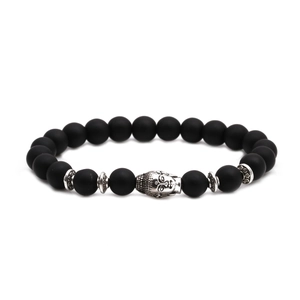Detailed macro shot of matte black agate beads with silver Buddha head and floral spacers