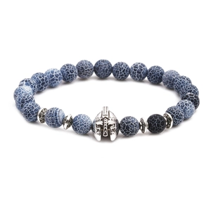 Detail of blue veined agate beads and a metallic Spartan helmet charm on a bracelet