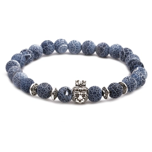 Detail of beaded bracelet with blue ice-crack beads and silver lion head charm