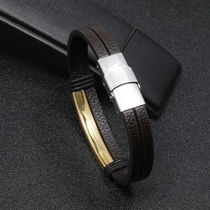 Men's double-layer brown leather bracelet with polished stainless steel clasp on dark background