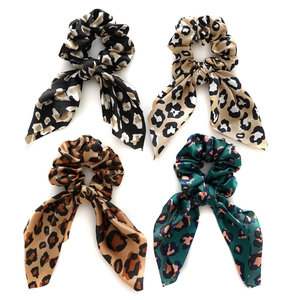Set of four satin leopard print hair scrunchies with rabbit ear bows in varied colors