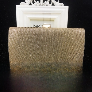 Detailed view of the gold sequin pleated evening clutch with metallic push-lock closure