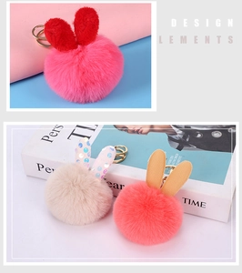 Detail view of plush bunny ear pompom keychains with sequins and gold metal rings
