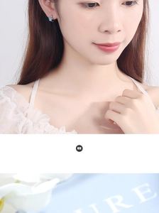 Close-up of model wearing cute blue paw print hoop earrings with sparkling zircon