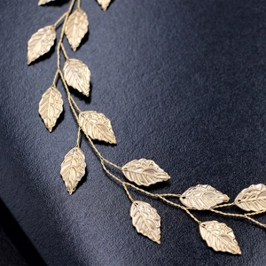 Elegant gold leaf bridal headband with intricate woven wire design for wedding hair