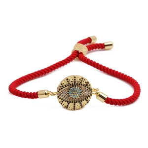 Adjustable red braided rope bracelet with golden evil eye pendant and blue zircon stones
