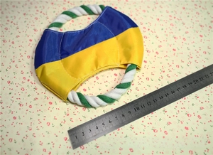 Detail view of cotton rope dog frisbee showing its 18cm diameter with a measuring scale