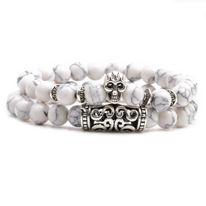 White turquoise beaded bracelet set featuring silver skull and metal tube charms