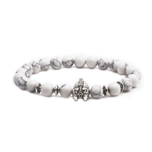 Detailed close-up of a white marble beaded bracelet with a silver Spartan helmet charm