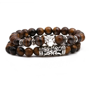 Macro detail of natural tiger eye beads and silver leopard head charm on the bracelet