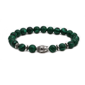 Macro detail of malachite bead bracelet featuring a silver-colored Buddha head charm